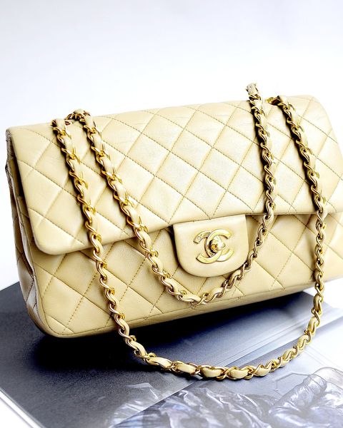 A cream quilted Chanel Classic Flap bag with gold chain strap and CC turn-lock
